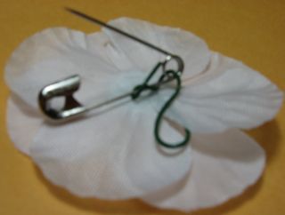Bend wire
                    (pinching centre of poppy) so pin is near middle.